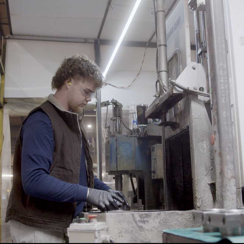 man-working-at-Okuno-International-making-hydraulic-cylinder-parts